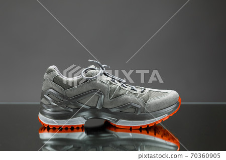 trekking sneaker with red sole, gray background trekking sneaker with red sole, gray background 70360905