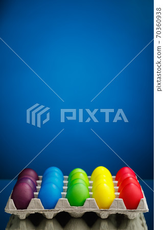 Easter festive multicolor eggs carton, blue background Easter festive multicolor eggs carton, blue background 70360938