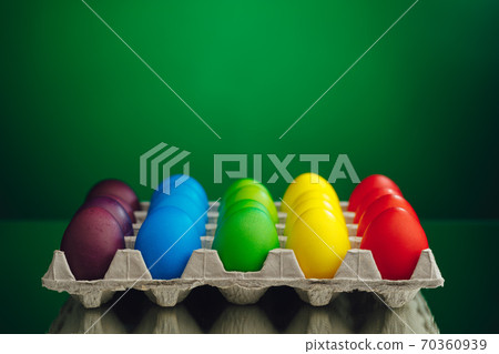 Easter festive multicolor eggs carton, green background Easter festive multicolor eggs carton, green background 70360939