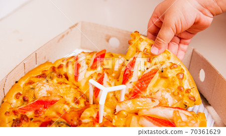 Hand of Little Child holding Delivery Pizza 70361629