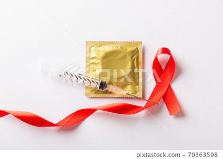 Red bow ribbon symbol HIV, AIDS cancer awareness, condom and syringe 70363598