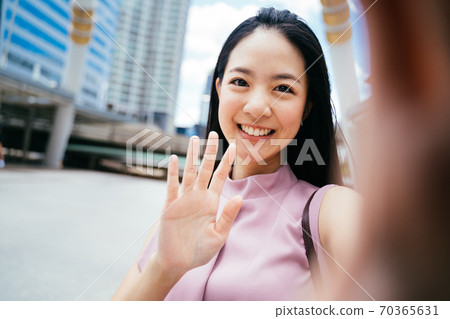 Young beautiful Asian businesswoman smiling towards camera 70365631