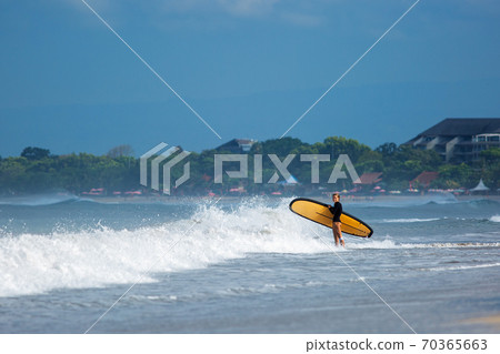 beautiful girl stands with a surfboard beautiful girl stands with a surfboard 70365663