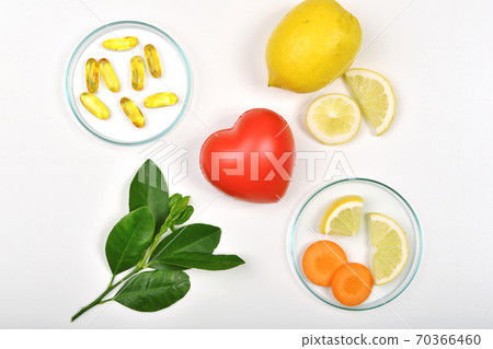 Heart model and Vitamin nutrition pills with fresh fruit and vegetable, Healthy diet 70366460