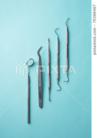 Dental instruments on green background 70366487