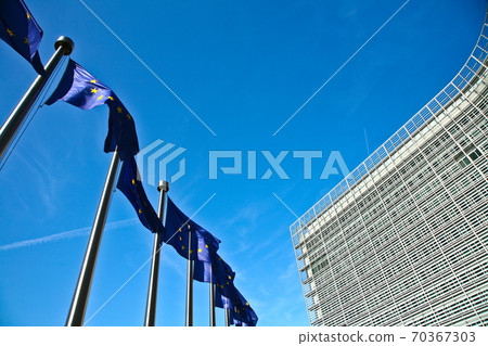 EU Flags in the wind in front of the Berlaymont building in Brussels 70367303