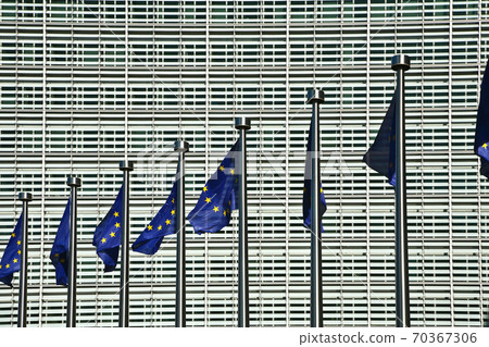 EU Flags in the wind in front of the Berlaymont building in Brussels EU Flags in the wind in front of the Berlaymont building in Brussels 70367306
