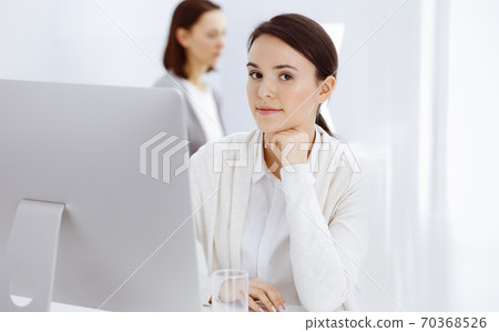 Casual dressed business woman working with computer in office. Lawyer or accountant at work 70368526
