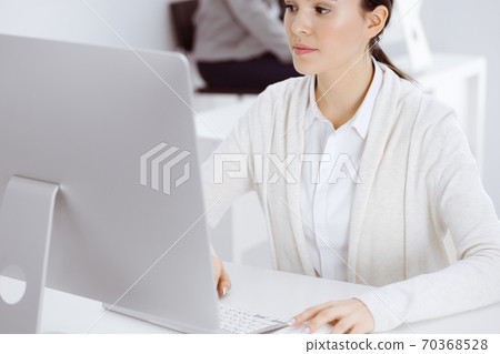 Casual dressed business woman working with computer in office. Lawyer or accountant at work 70368528