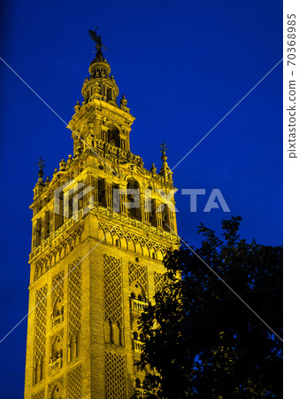 Bell Tower named Giralda in catholic Cathedral of Saint Mary in Seville, Spain 70368985