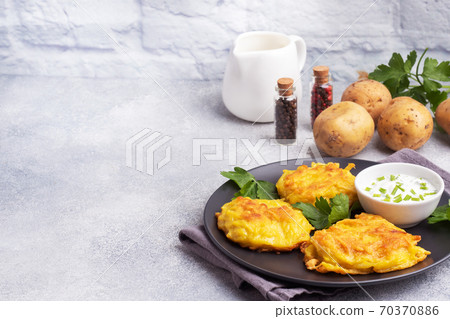 Fried cakes of grated potatoes on the plate with sauce. Traditional pancakes boxty raggmunk. 70370886