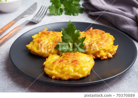 Fried cakes of grated potatoes on the plate with sauce. Traditional pancakes boxty raggmunk. 70370889