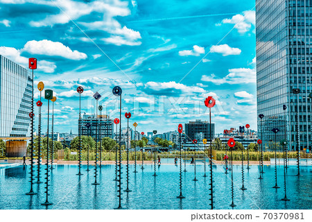 PARIS, FRANCE - JULY 06, 2016 :La Defense, Business Quarter with businessmen in the streets, area of Paris, French financial center with skyscrapers and modern buildings. PARIS, FRANCE - JULY 06, 2016 :La Defense, Business Quarter with businessmen in the streets, area of Paris, French financial center with skyscrapers and modern buildings. 70370981