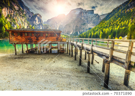 Wooden boathouse and boats on the alpine lake, Dolomites, Italy 70371890