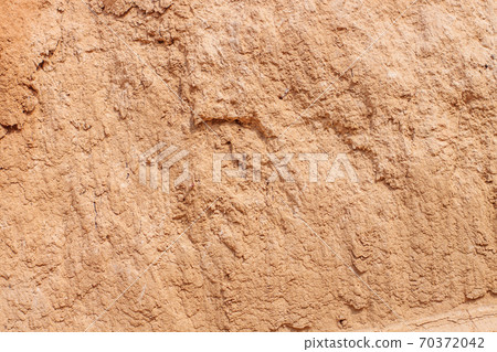 Background of great clay wall or brown ocher. Grunge rock texture Cracked ground texture in vintage style. Canyon rock. 70372042