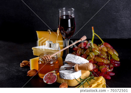 Beautiful delicious camembert cheese, parmesan, brie with grapes and figs 70372501
