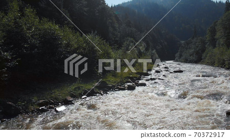 Fast flowing river. Fast flowing river. 70372917