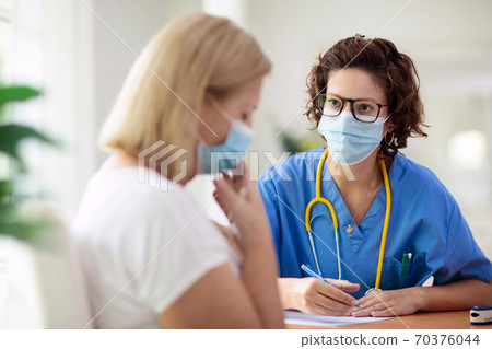 Doctor examining sick patient. Ill woman in clinic 70376044