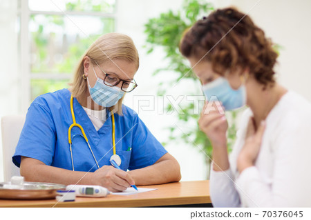 Doctor examining sick patient. Ill woman in clinic 70376045