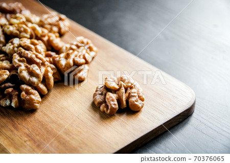 Walnut kernels on a cutting board Walnut kernels on a cutting board 70376065