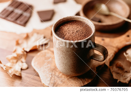Close-up of hot chocolate on the table. Autumn or winter cozy still life. 70376705