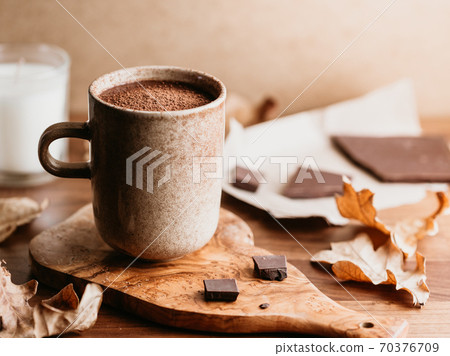 Close-up of hot chocolate on the table. Autumn or winter cozy still life. Close-up of hot chocolate on the table. Autumn or winter cozy still life. 70376709