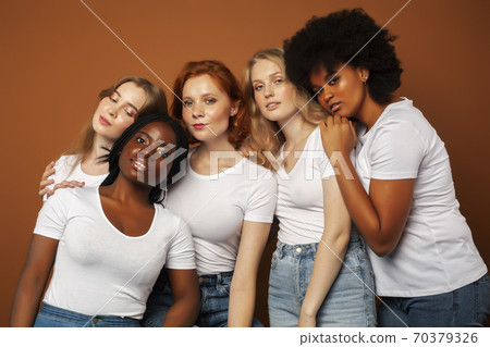 young pretty asian, caucasian, afro woman posing cheerful together on brown background, lifestyle diverse nationality people concept young pretty asian, caucasian, afro woman posing cheerful together on brown background, lifestyle diverse nationality people concept 70379326
