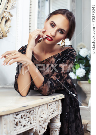 young pretty lady in black lace fashion style dress posing in rich interior of royal hotel room with mirror, luxury lifestyle people concept young pretty lady in black lace fashion style dress posing in rich interior of royal hotel room with mirror, luxury lifestyle people concept 70379343