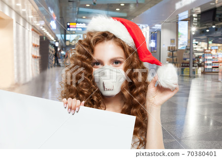Pretty woman Santa in protective medical mask  70380401