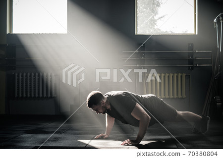 Muscular Man Do Push Ups at Male Gym . 70380804