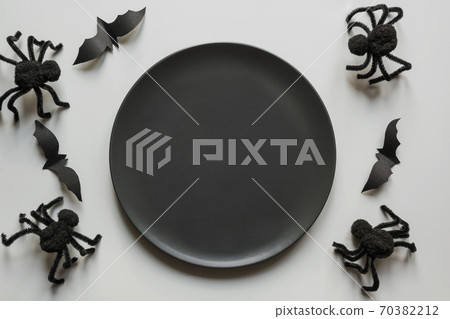Halloween party table setting with black spiders 70382212