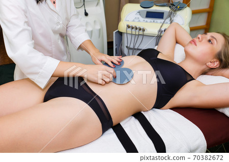 Modern massage of myostimulation of body muscles. Modern massage of myostimulation of body muscles. 70382672