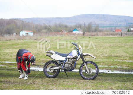 Motorcyclist getting prepared for the cross 70382942