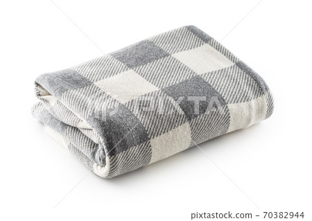 Folded grey and white checkered blanked on an Folded grey and white checkered blanked on an 70382944