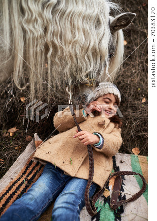 Girl Having Fun With Pony 70383120