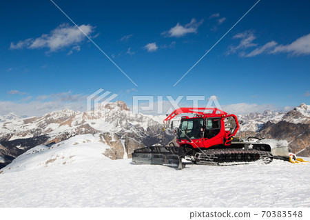 Red snowcat ratrack mountain panorama Red snowcat ratrack mountain panorama 70383548