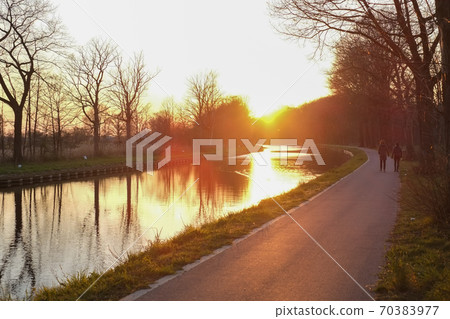 Panorama of a gorgeous scenic sunset at a river or canal Panorama of a gorgeous scenic sunset at a river or canal 70383977