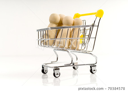 Wooden stick figure in a trolley on a white background. 70384578