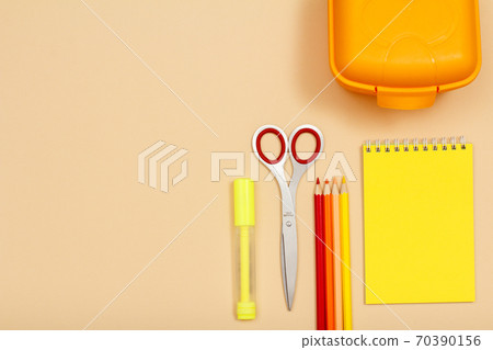 Felt pen, scissors, color pencils, lunch box and notebook on beige background Felt pen, scissors, color pencils, lunch box and notebook on beige background 70390156