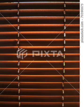 Closed golden jalousie texture with sunlight in the morning. Window with blinds interior design of living room decor. Closed golden jalousie texture with sunlight in the morning. Window with blinds interior design of living room decor. 70390873
