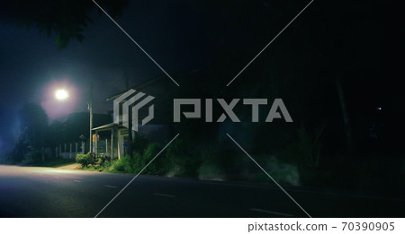 Old wooden house and smoke at night . Horror scene 70390905