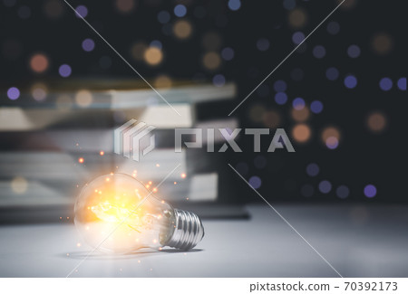 Book and light bulb style vintage dark background,Concept 70392173