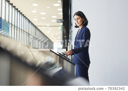 Businesswoman Entering Office Building through Automatic Gate Businesswoman Entering Office Building through Automatic Gate 70392342