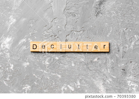 Declutter word written on wood block. Declutter text on cement table for your desing, concept 70393380