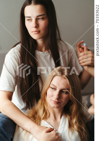 Woman supporting and comforting her sad friend Woman supporting and comforting her sad friend 70393622