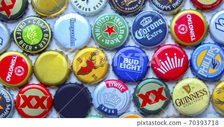 Calgary, Alberta, Canada. Oct 11, 2020. Various domestic craft beer caps of imported beers from around the world rotating. Calgary, Alberta, Canada. Oct 11, 2020. Various domestic craft beer caps of imported beers from around the world rotating. 70393718