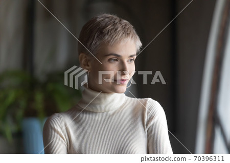 Motivated Caucasian businesswoman look in distance dreaming Motivated Caucasian businesswoman look in distance dreaming 70396311