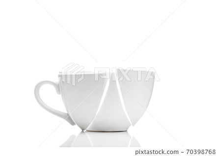 white ceramic cup broken into fragments as a result of the fall, a concept of a kitchen object on the theme of crisis on a white background with copy space. white ceramic cup broken into fragments as a result of the fall, a concept of a kitchen object on the theme of crisis on a white background with copy space. 70398768