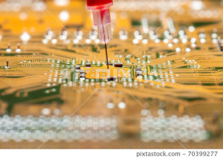 modern technologies of treatment and vaccination medicine research, silicone circuit board with a syringe with a needle filled with a red drug close-up. modern technologies of treatment and vaccination medicine research, silicone circuit board with a syringe with a needle filled with a red drug close-up. 70399277