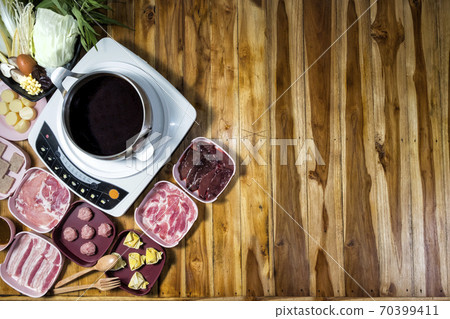 Thai style hot pot with delicious food ingredient on wood background and space for text Thai style hot pot with delicious food ingredient on wood background and space for text 70399411